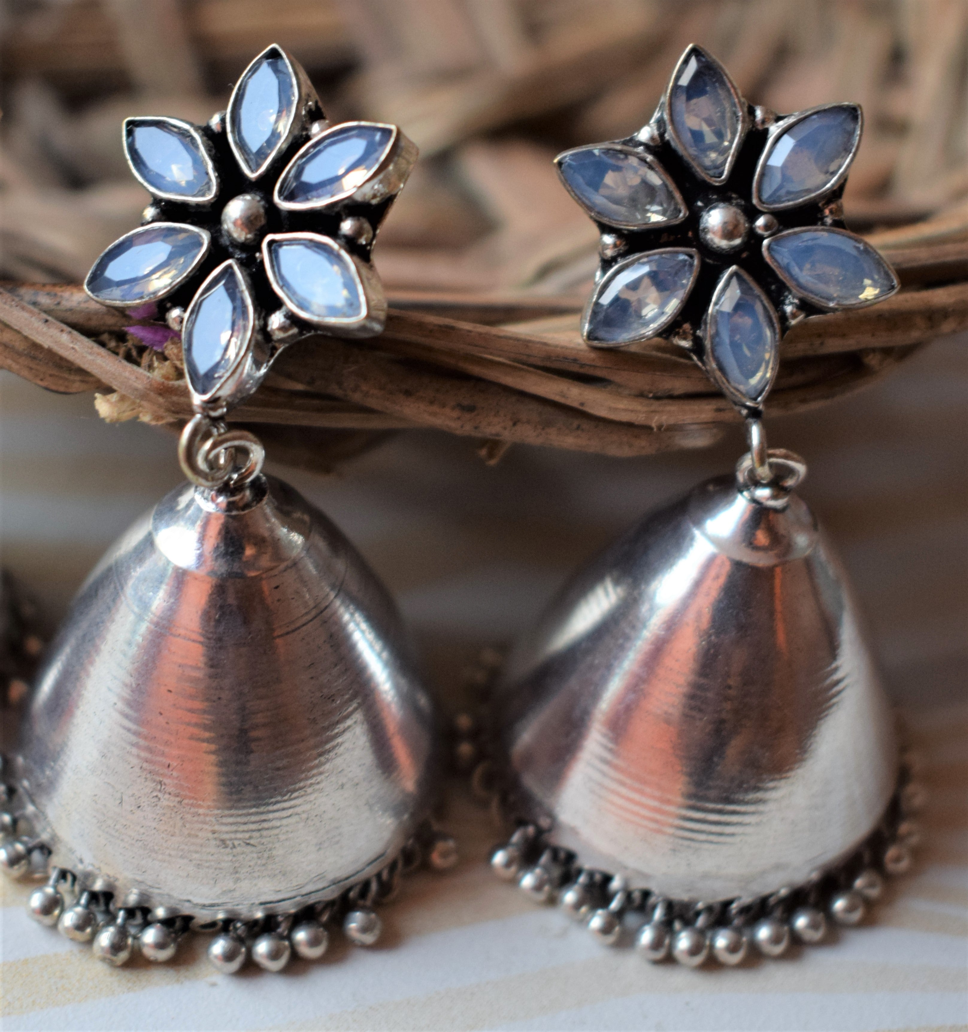 Designer Gemstone Flower Smooth German Silver Jhumka – Glitter Gleam - Main Image