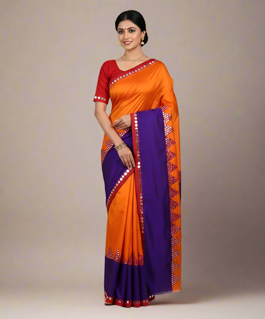Woman wearing an orange and purple saree with a red blouse on a beige background