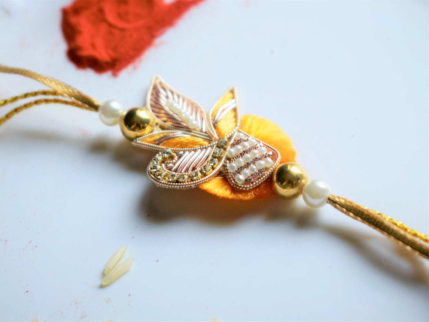 Zardozi and Pearl Peacock Traditional Rakhi (Yellow)